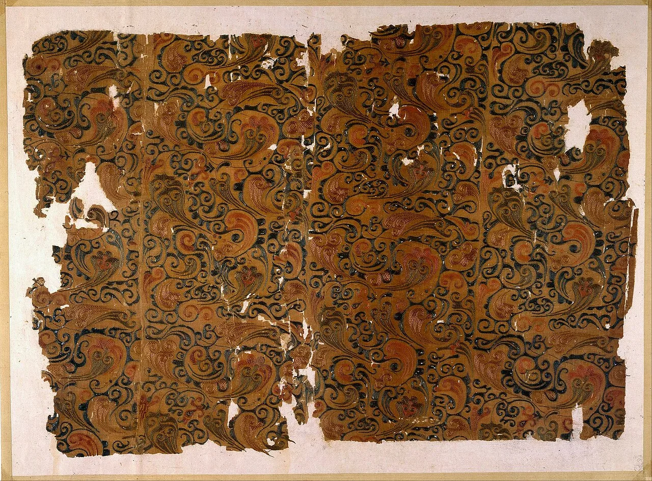 An embroidered silk textile with intricate decorative designs from Hunan Museum.