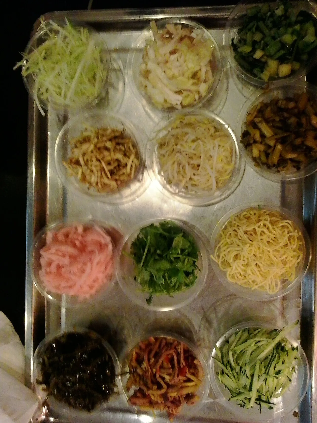 Thin wrappers and small dishes of vegetables for Guiyang siwawa.