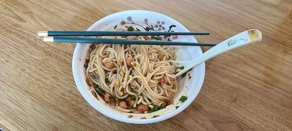 A bowl of Nanchang mixed rice noodles with colorful toppings.