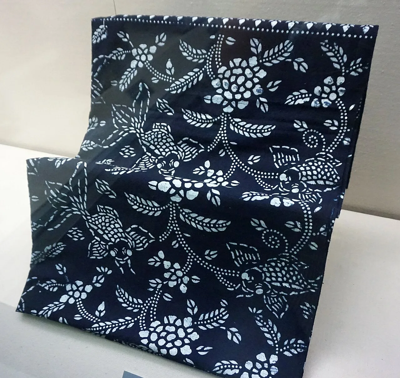 Blue-and-white resist-printed cloth with bird and flower motifs.