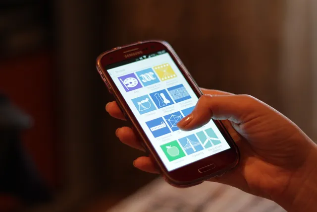 Using a smartphone. A subject photograph; it does not show a particular Chinese mobile network or eSIM service.