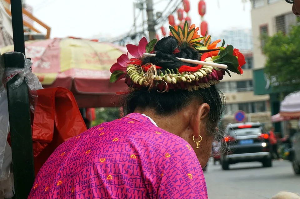 A Xunpu woman wearing a ring of flowers around her hair.