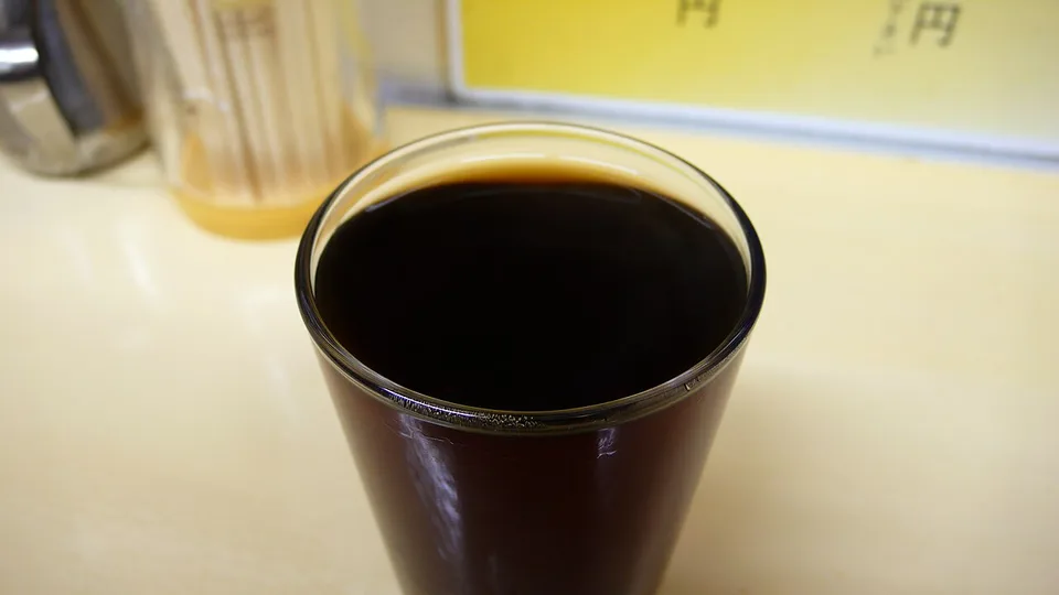 Amber Shaoxing rice wine served in a small glass.