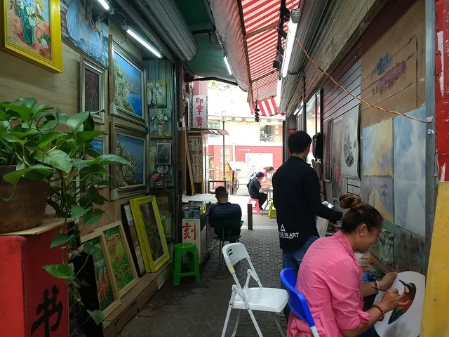 Artists painting canvases in Shenzhen’s Dafen Oil Painting Village.