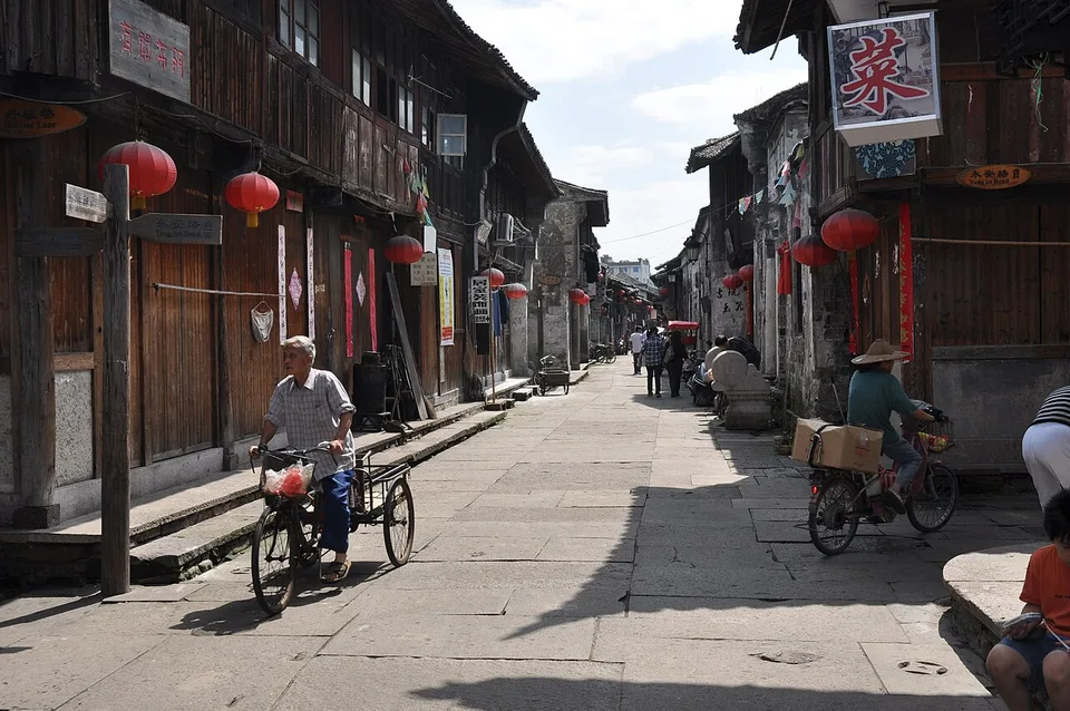 Historic storefronts and visitors on Ziyang Street in Linhai.