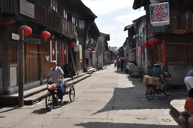 Historic storefronts and visitors on Ziyang Street in Linhai.